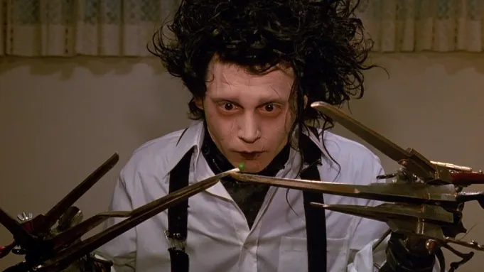 Edward Scissorhands, a gentle man with scissors for hands who falls in love with a suburban girl, in Edward Scissorhands (1990).