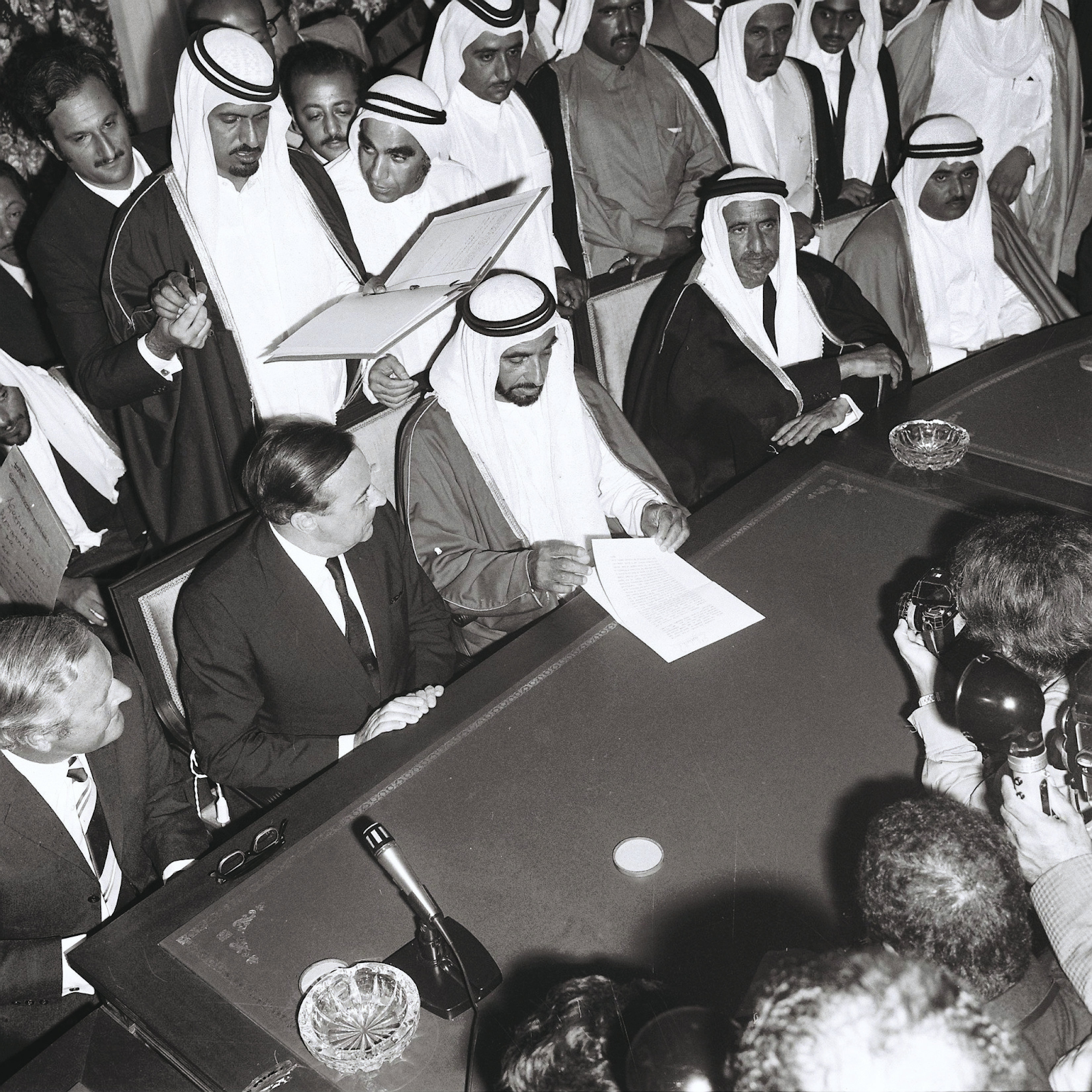 Photo of the Sheikh Zayed signing the union agreement papers